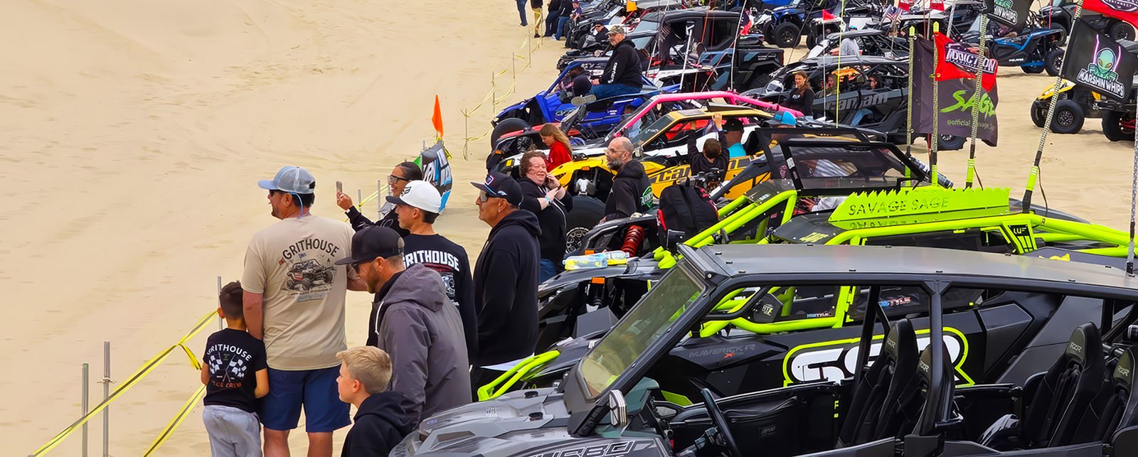 Crowd and UTVs gathered at an off-road motorsports event